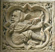 Panel 09:03 - Seated man with beard, hood and staff, facing backwards